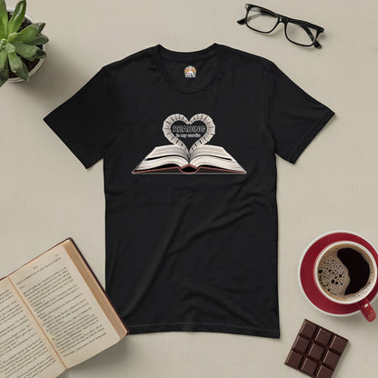 Black "Reading Is My Cardio" tee with open book design, surrounded by coffee, glasses, chocolate, and plants.