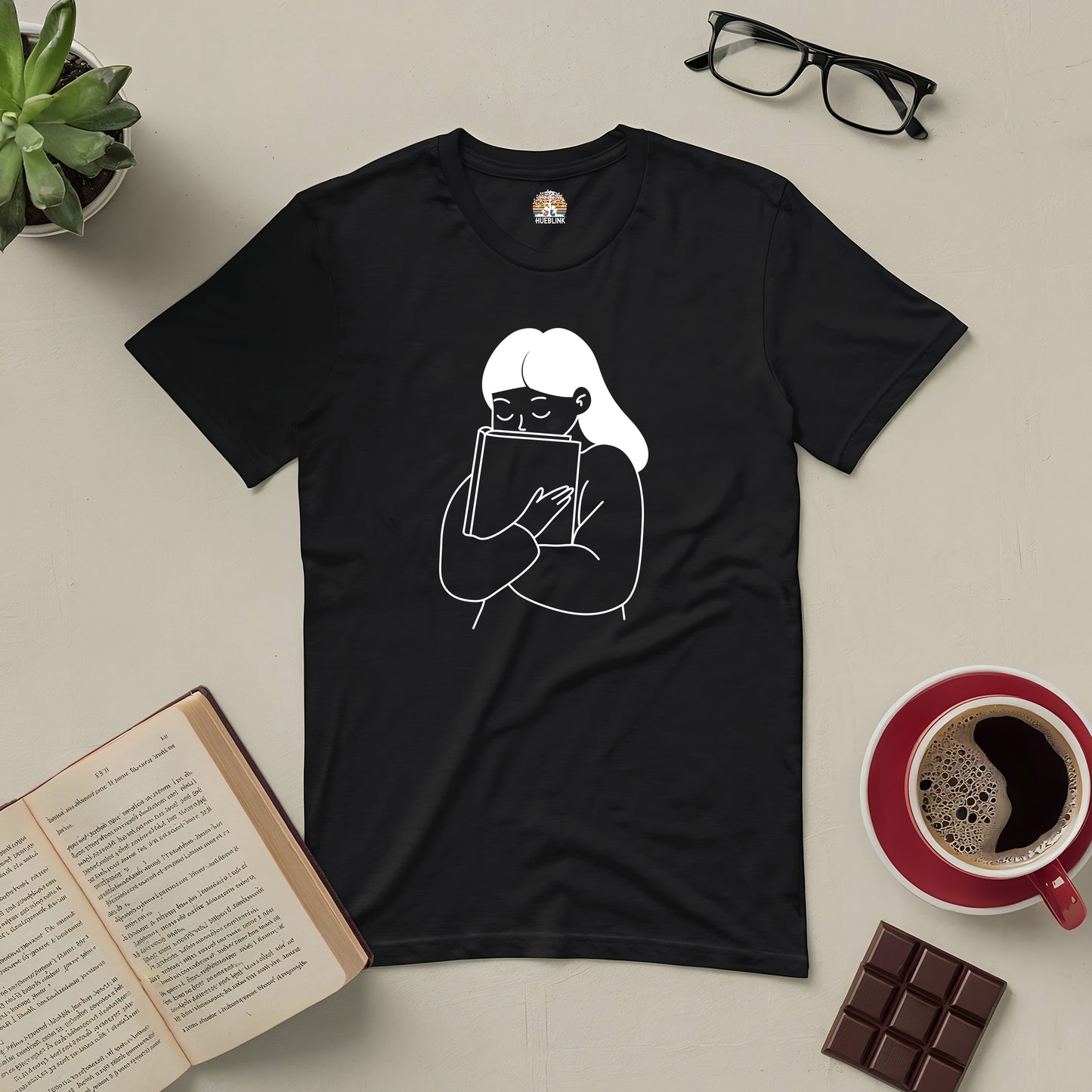 "Me And My Bestie Tee for book lovers featuring minimalistic design of reader hugging book, surrounded by coffee, chocolate, and open book."