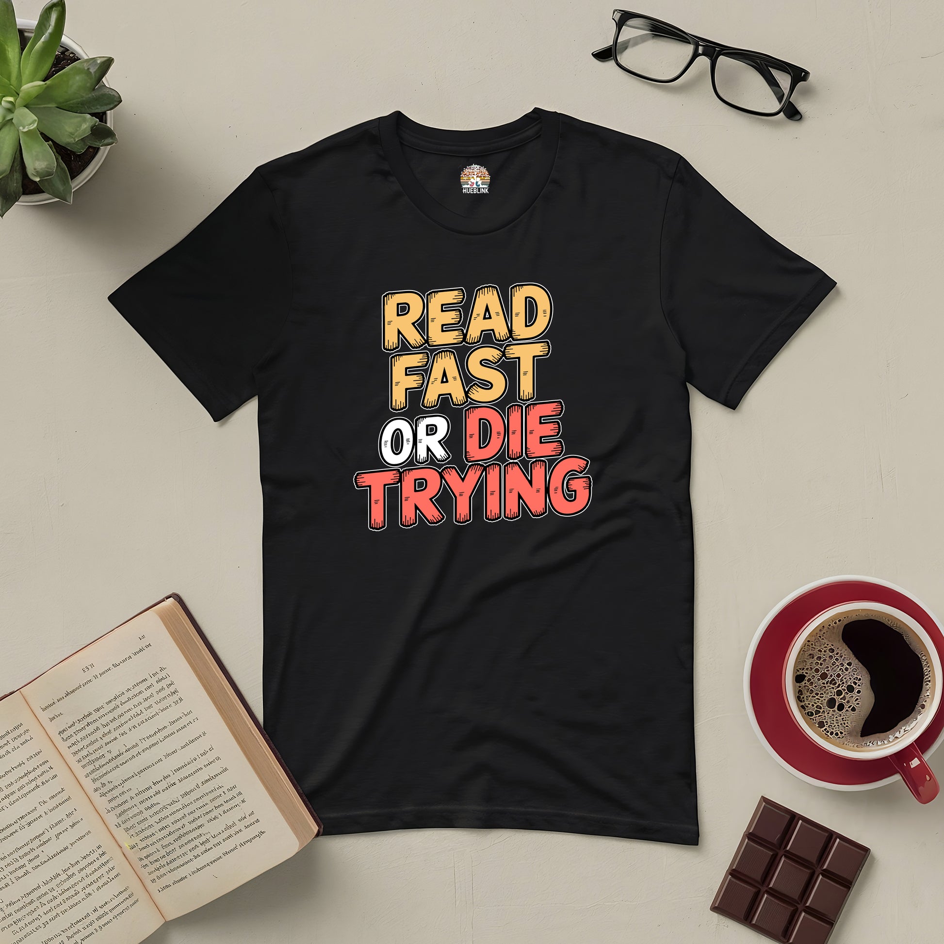 "Read Fast or Die Trying tee for passionate readers, with book, coffee, and chocolate on table"