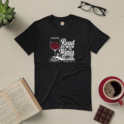 Black "Read Between the Wines" tee with wine and book design, perfect for book and wine lovers.