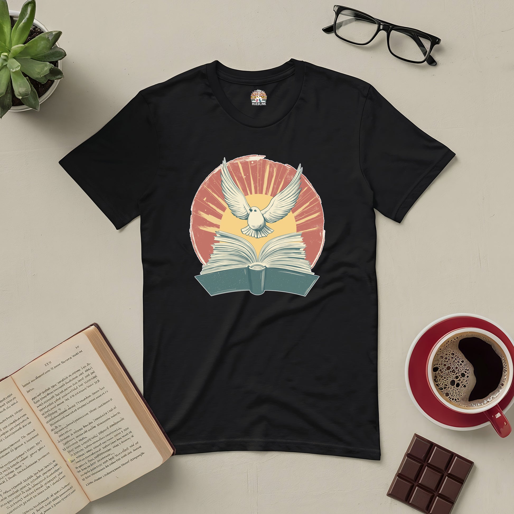 Black Boundless Horizons Tee featuring a dove and open book graphic, surrounded by a warm color burst; perfect for book lovers.