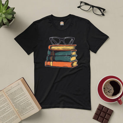 Black t-shirt with vintage books and glasses design for stylish readers, surrounded by open book, glasses, coffee, and chocolate.