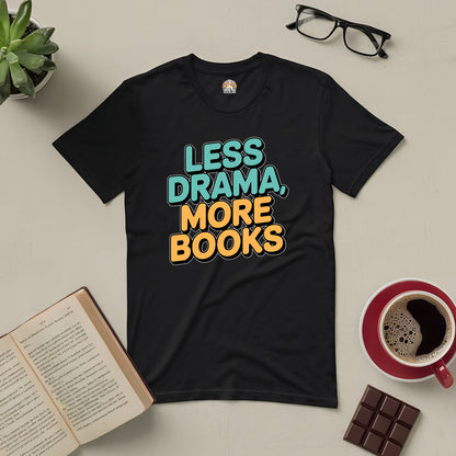 Black "Less Drama, More Books" tee with book, glasses, coffee, and chocolate on a table. Perfect for book lovers.