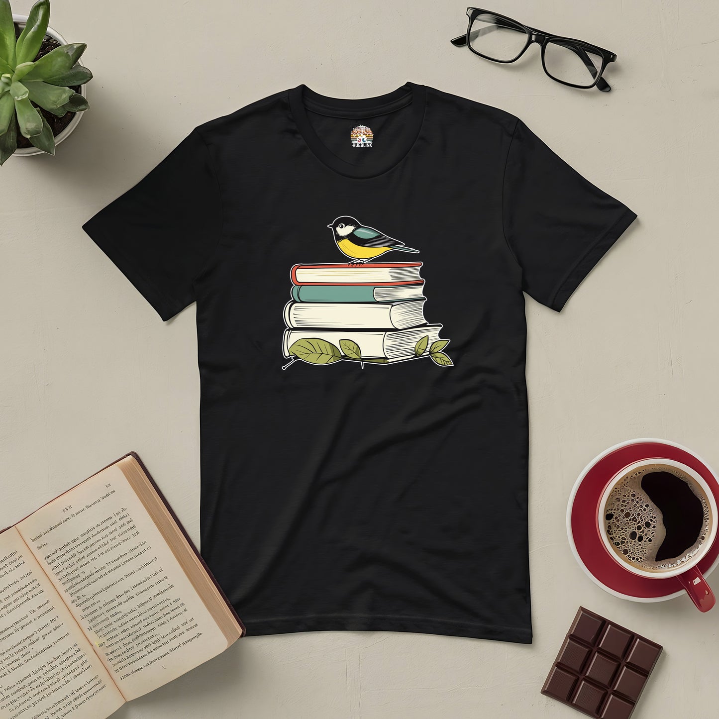 "Nestled in Stories tee with bird on books, perfect for book lovers and nature enthusiasts"