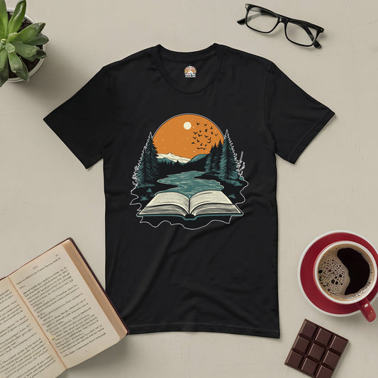 Absorbed in Nature Tee with book and forest design, perfect for book lovers and nature enthusiasts, displayed with coffee and chocolate.