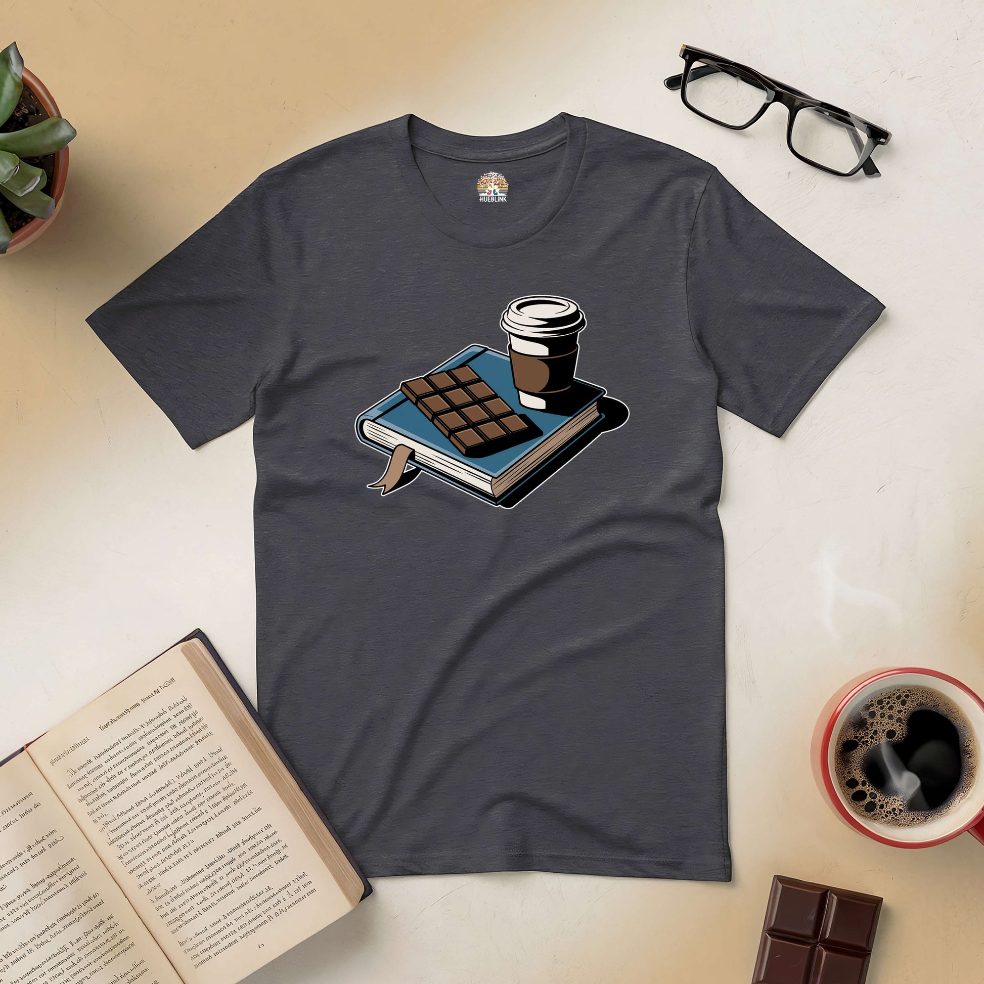 Cozy book, coffee, and chocolate scene on Sweet Moments Tee for book lovers.