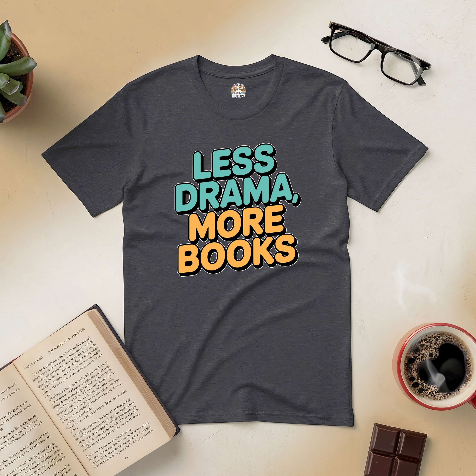 "Less Drama More Books tee with books, glasses, and coffee, ideal for book lovers seeking peace and simplicity."