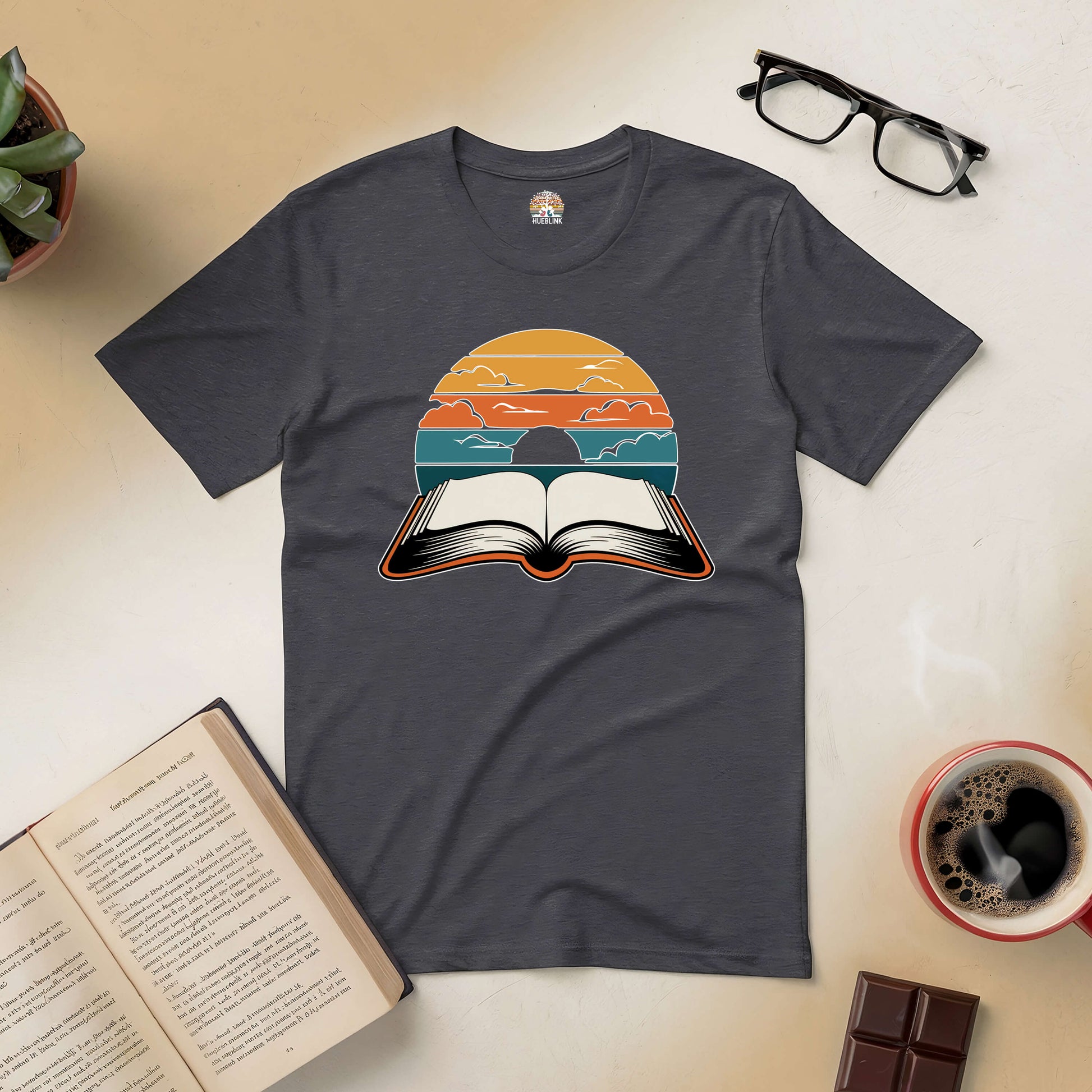 Dark tee with "Narratives in Color" design featuring an open book under a vibrant sunset sky, symbolizing colorful stories in reading.