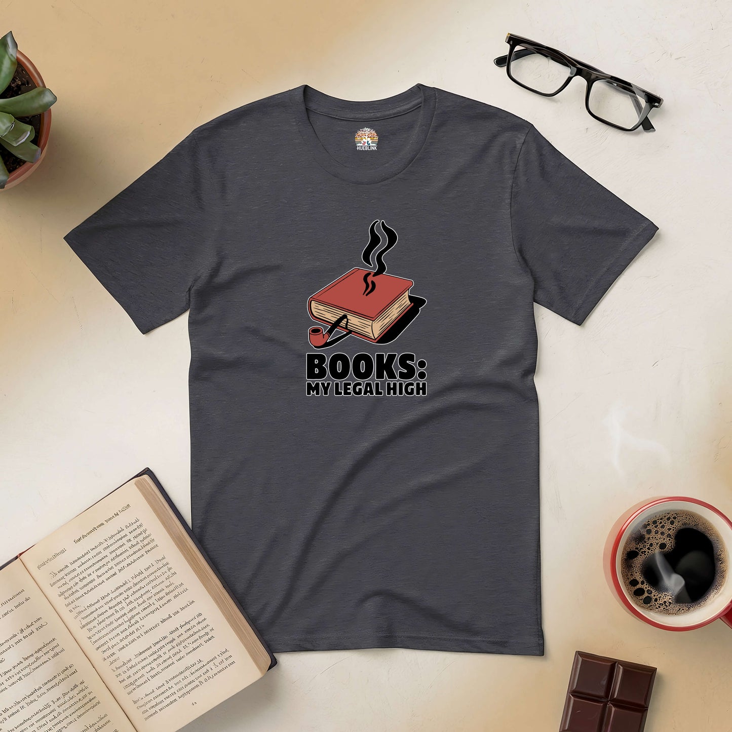 "Books: My Legal High tee with book design on table, surrounded by coffee, glasses, and open book."