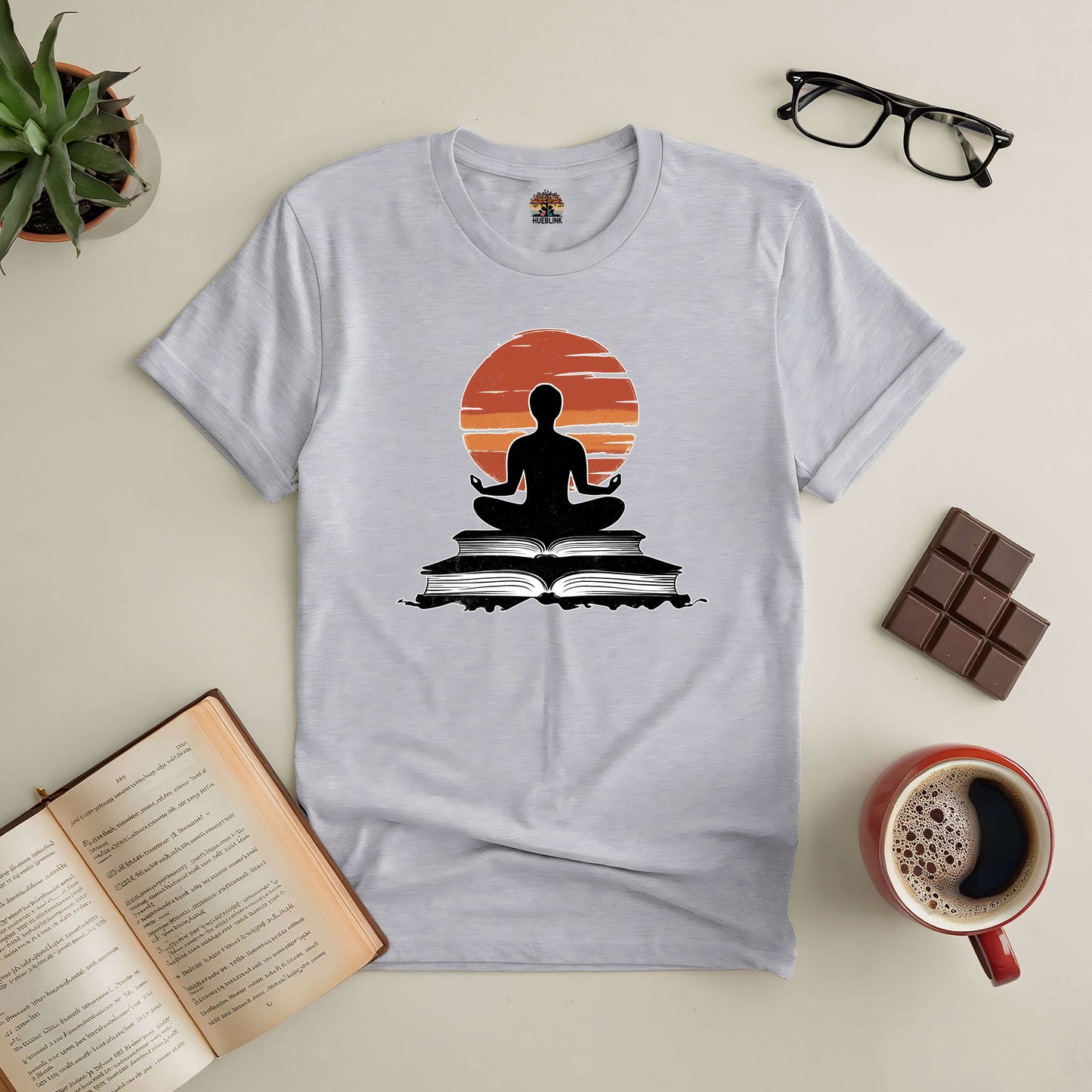 Gray "Connection Established" tee featuring a meditative figure on books, surrounded by glasses, chocolate, coffee, and an open book.