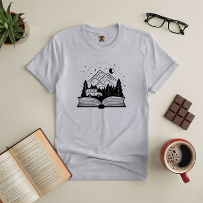 "A Trip From Cover To Cover Tee with book print, surrounded by open book, coffee, and chocolate"