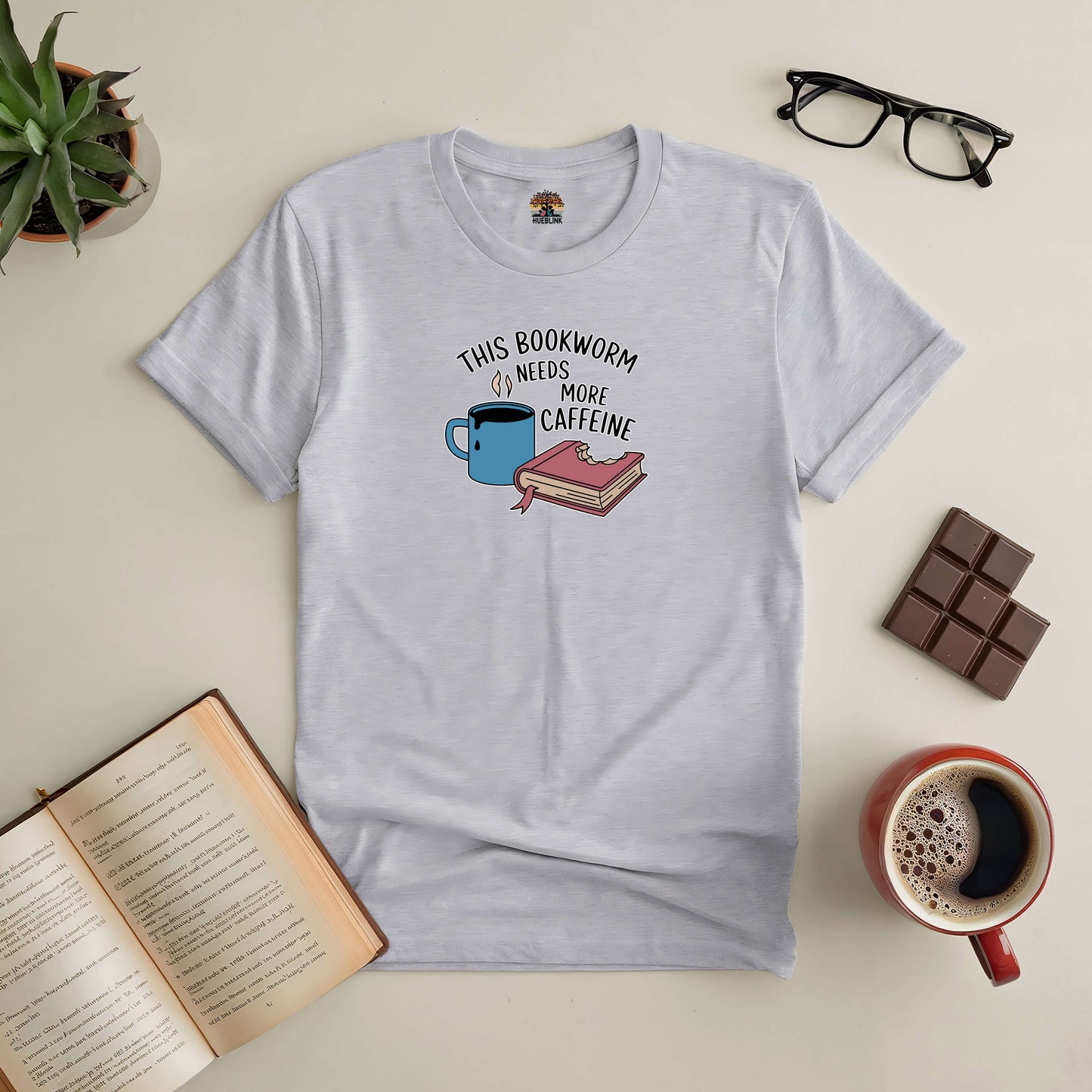 Caffeine-themed tee for book lovers, featuring a blue coffee cup and books, ideal for passionate readers who love caffeine boosts.