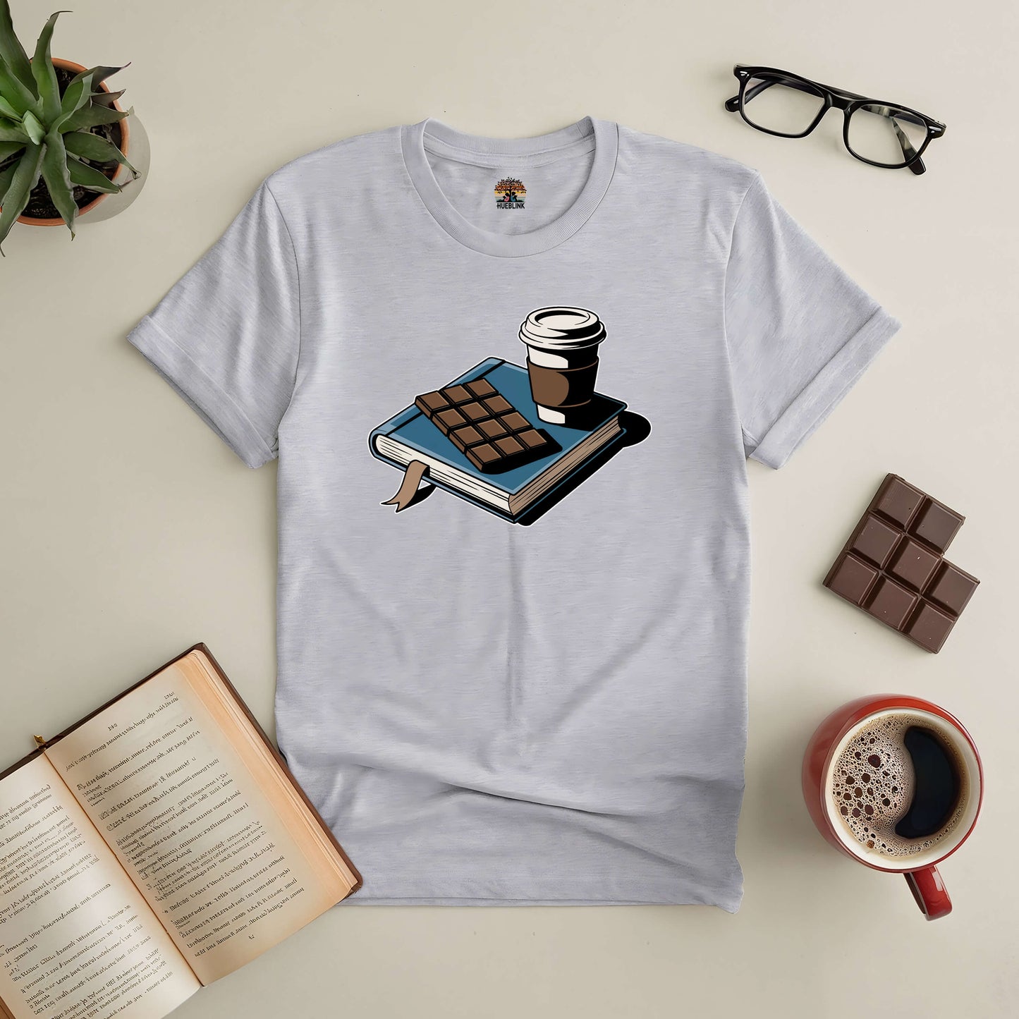 "Sweet Moments Tee featuring book, coffee, and chocolate design, perfect for book lovers who enjoy life's simple pleasures"