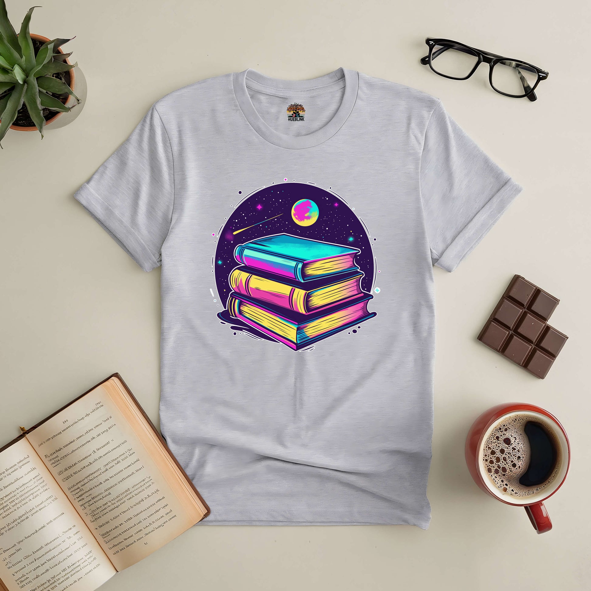 "Portal to Infinite Universes Tee featuring vibrant book design with coffee and chocolate flatlay"