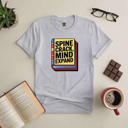 "Spine Crack, Mind Expand Tee with book and coffee, celebrating worn pages and open minds on a gray T-shirt"