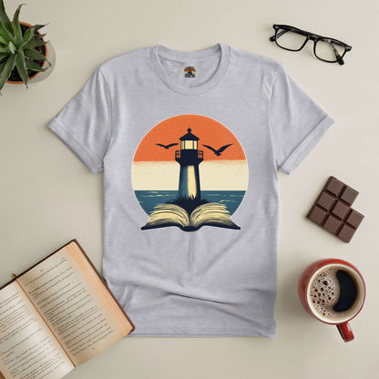 "The Guide I Need Tee with lighthouse and open book design, surrounded by reading glasses, chocolate, and coffee"