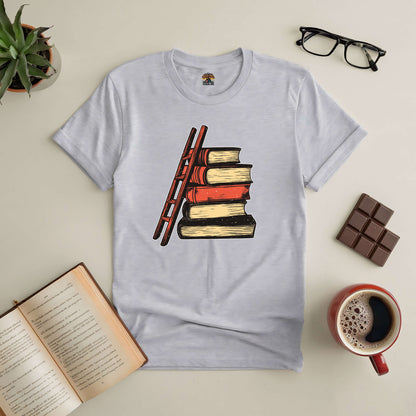 "Reaching New Heights Tee with ladder and book design, symbolizing the journey of readers aiming higher with each story explored."