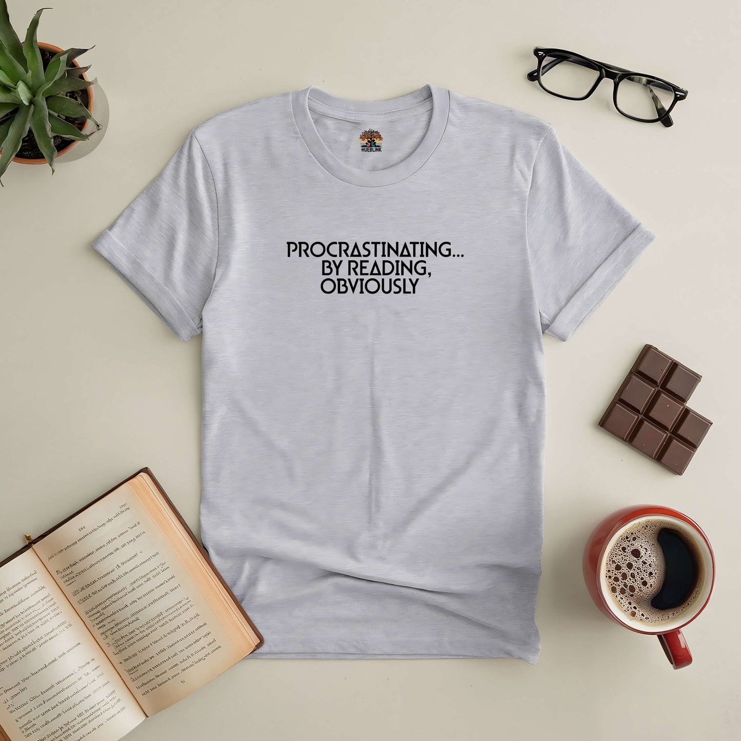 "Procrastinating By Reading Obviously tee with book and coffee, perfect for book lovers choosing reading over tasks."