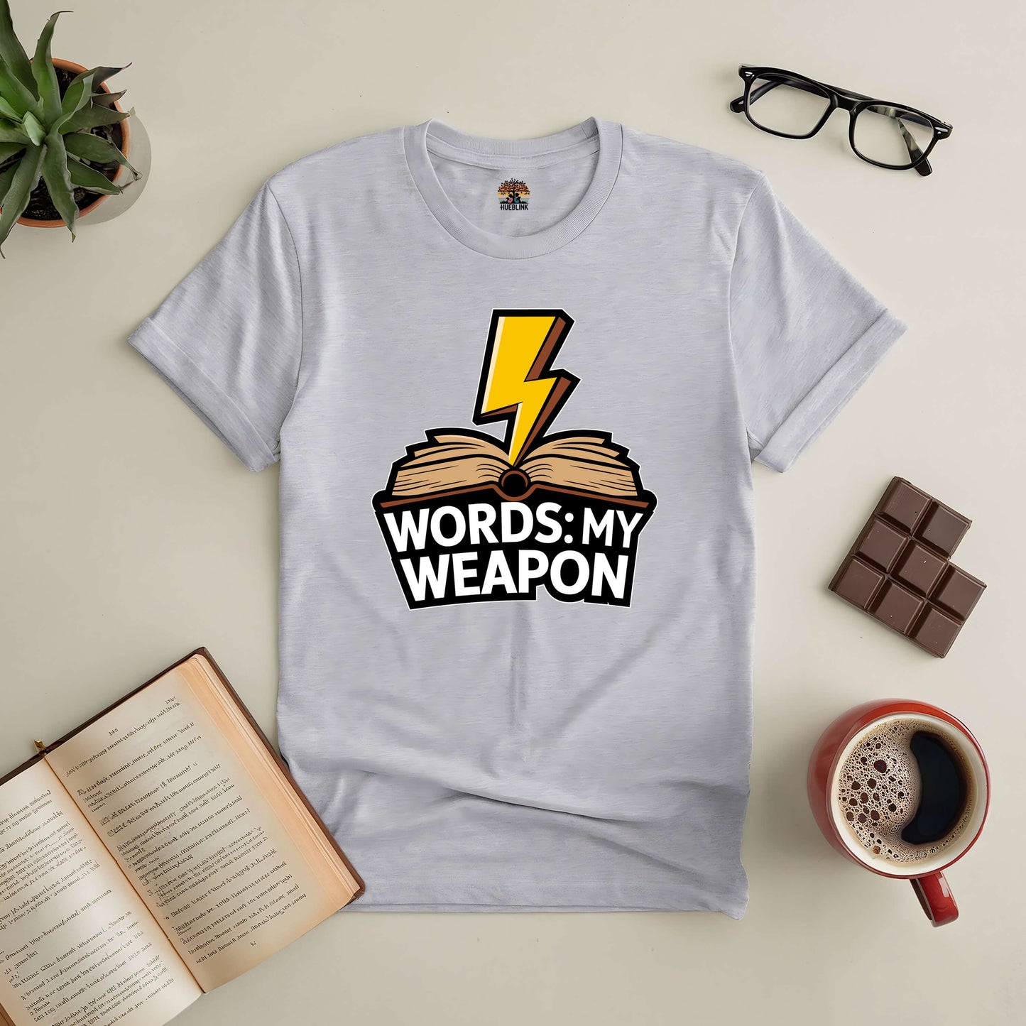 "Words: My Weapon Tee featuring lightning bolt and book design, emphasizing the power of language over violence."