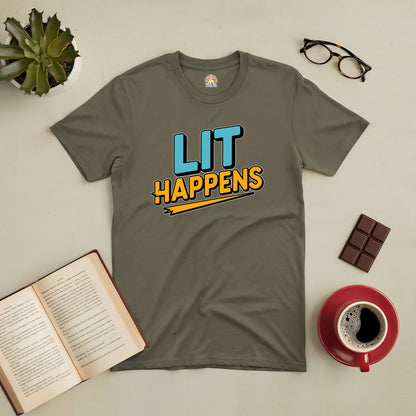 Olive green Lit Happens Tee for book lovers, with a playful twist, laid out with a book, coffee, and chocolate on a table.