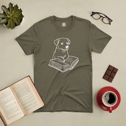 "Pawsitive Read Tee featuring cute pup with book, surrounded by an open book, coffee, chocolate, and glasses."