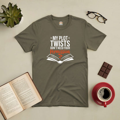 Olive green tee with "My Plot Twists Don't Need Your Permission" text, surrounded by a book, glasses, coffee, and chocolate.