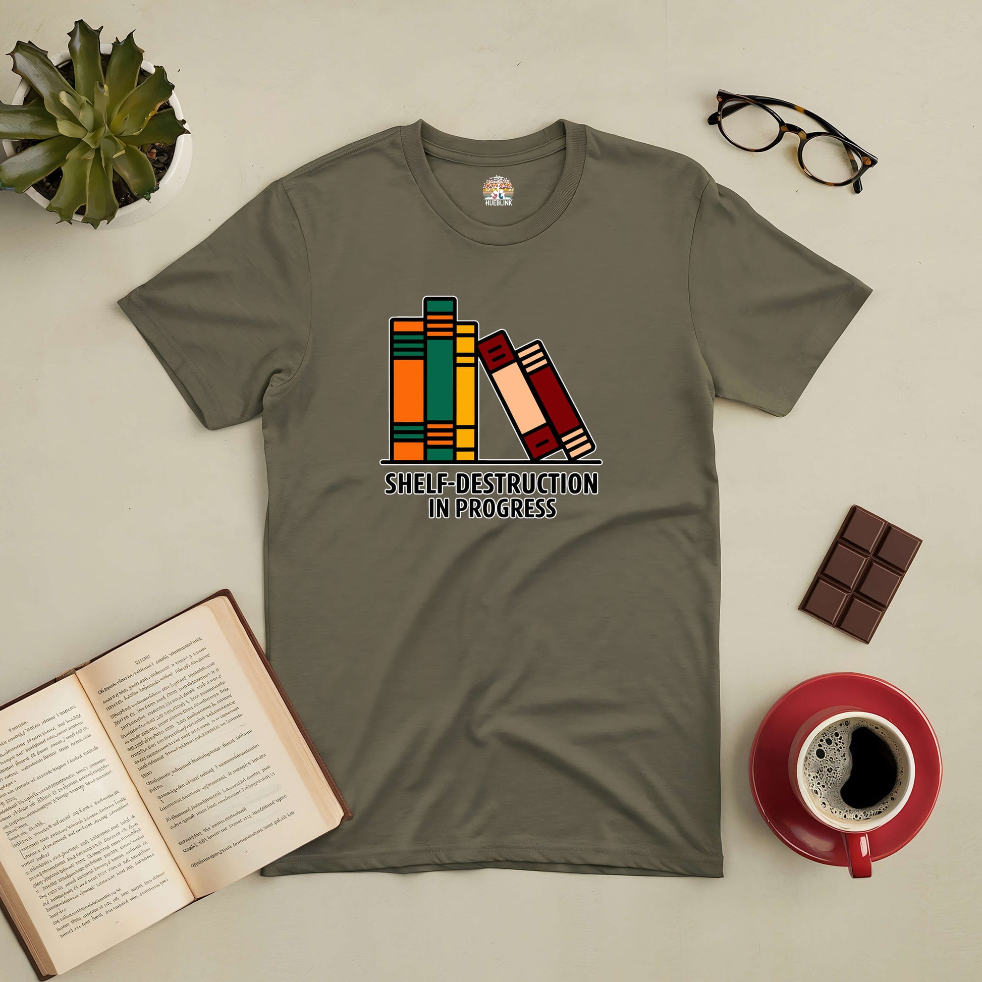 Green tee with "Shelf-Destruction In Progress" design, featuring colorful books. Perfect for book lovers.