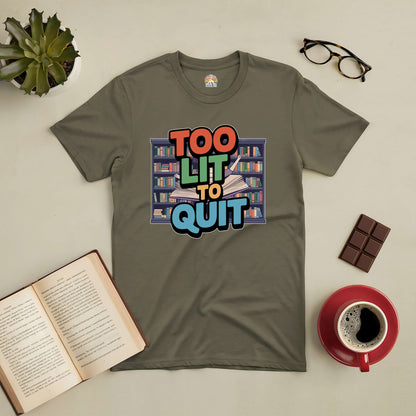 "Too Lit To Quit Tee with bookshelf design for book lovers, displayed with open book, coffee, glasses, chocolate, and a plant."