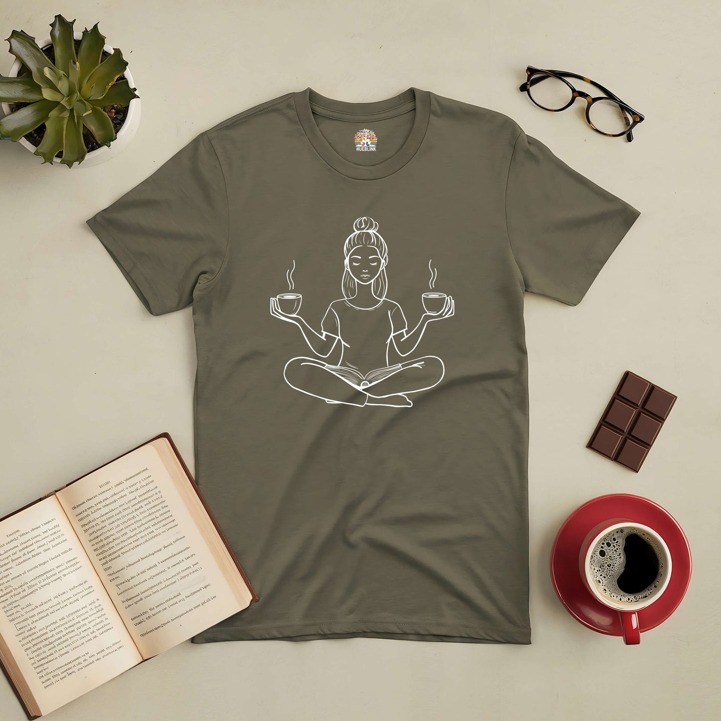 Perfectly Balanced Tee featuring a zen design with a person holding coffee cups, surrounded by an open book and coffee on a table.