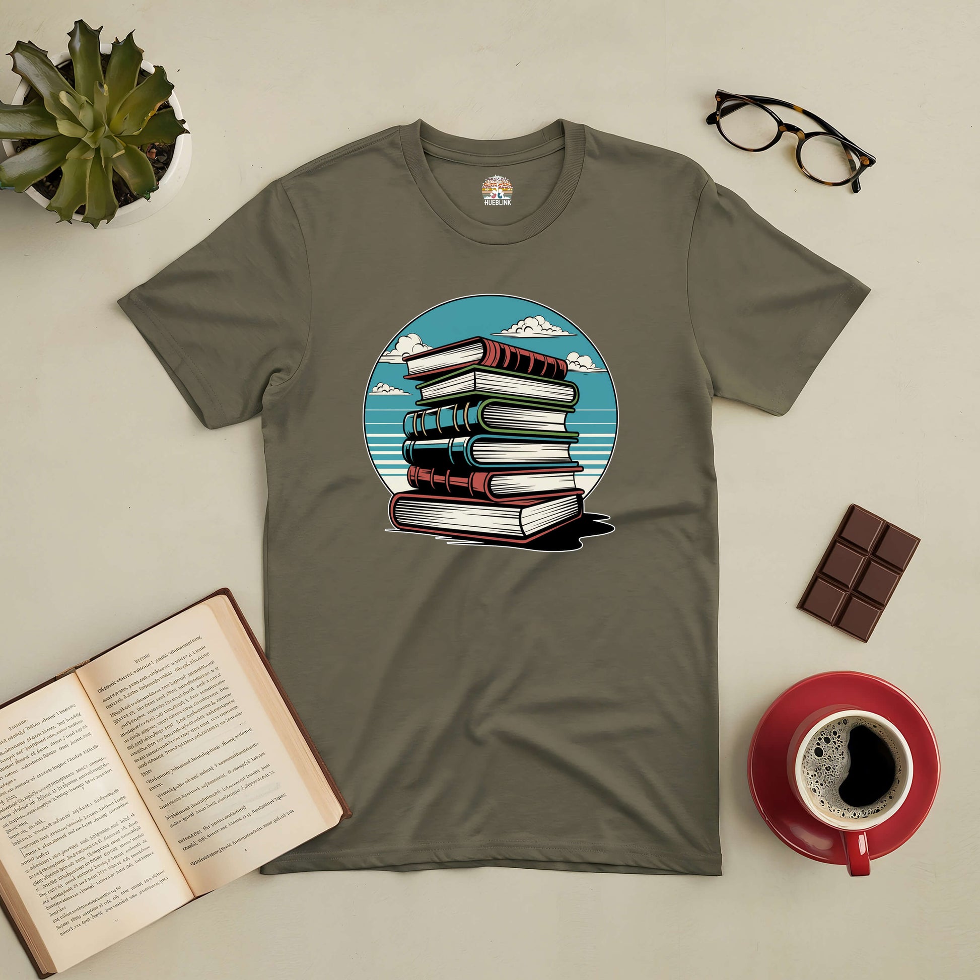 A serene Silent Knowledge Tee featuring a stack of books against an open sky, ideal for introspective readers seeking timeless wisdom.