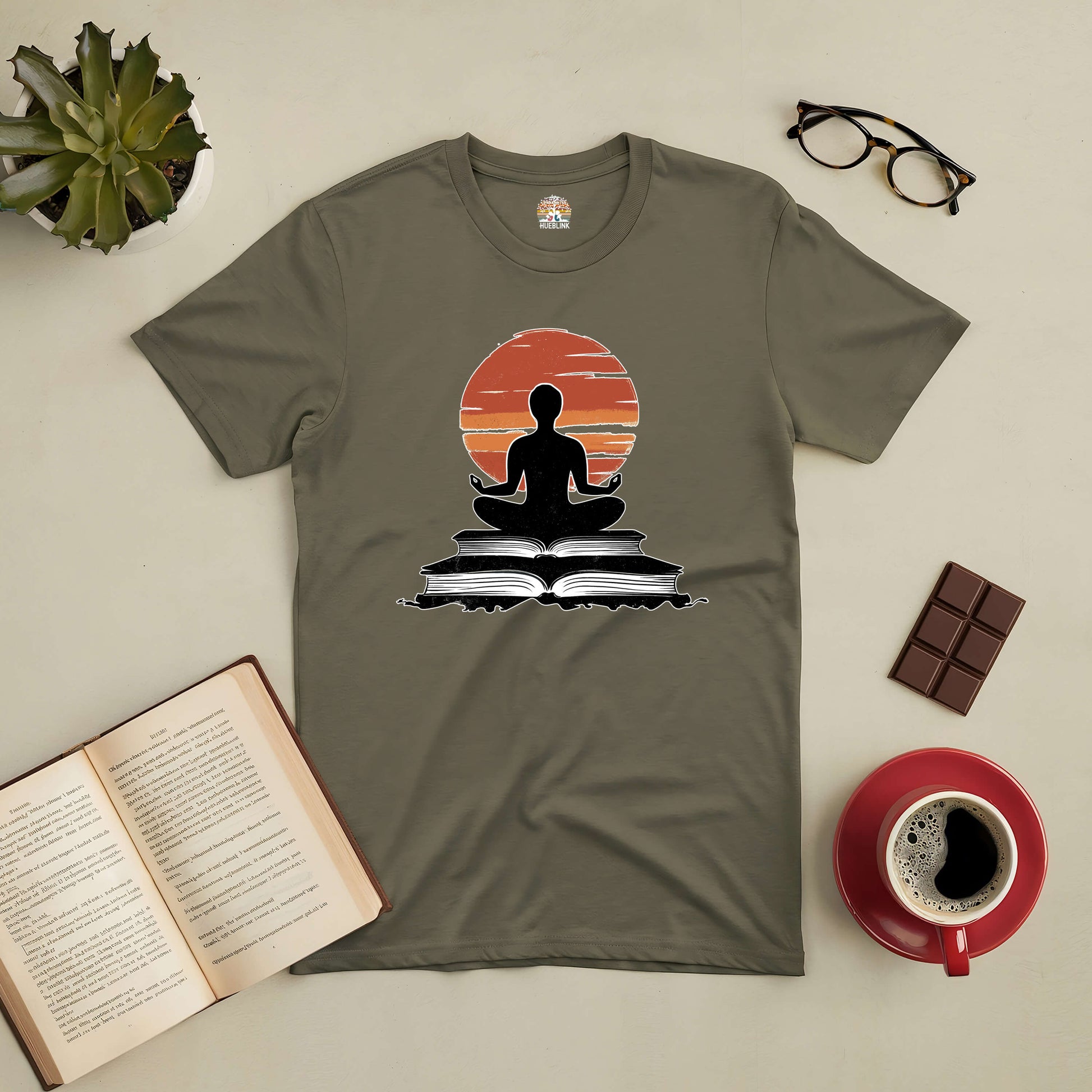 "Connection Established Tee with meditative figure, open books, coffee cup, and glasses, capturing calm and balance in reading"