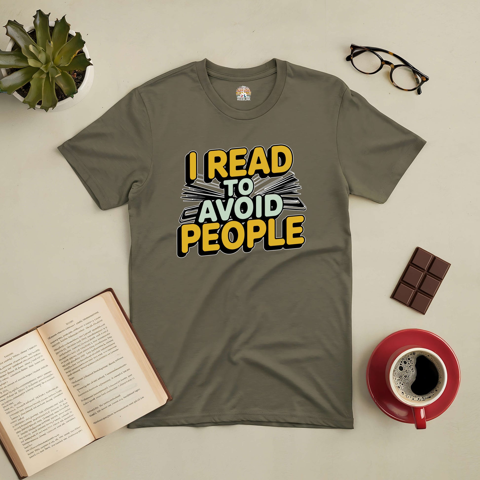 "I Read To Avoid People Tee for introverts with books, coffee, and glasses on a table"