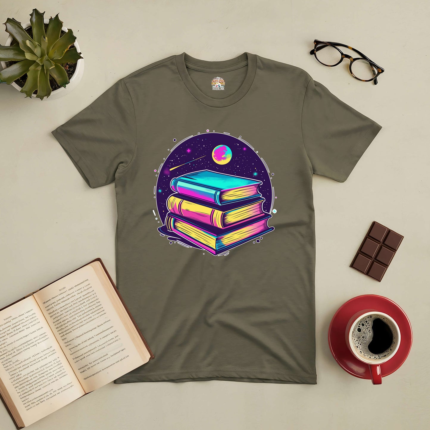 "Portal to Infinite Universes Tee with vibrant book design, celebrating imagination and books as gateways to endless worlds, surrounded by coffee, glasses, and an open book."