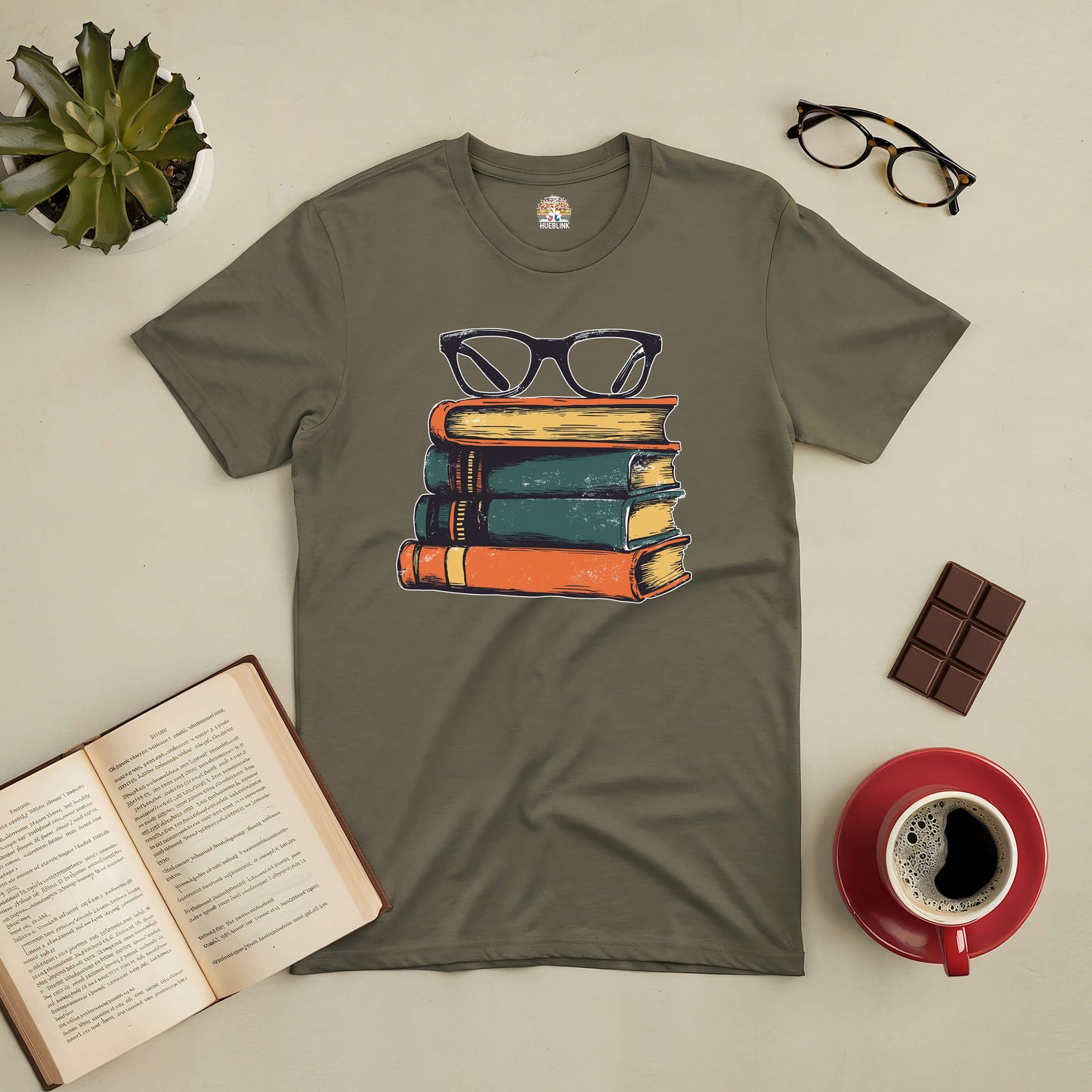 Olive green tee with vintage book stack and glasses design, ideal for readers and fashion enthusiasts.