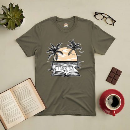 Beachside Bibliophile Tee with sunset and open book graphic, surrounded by palm trees, glasses, coffee, chocolate, and an open book.