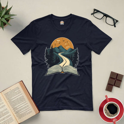 Starting Point Tee with open book graphic depicting a journey through mountains, perfect for book lovers and adventurers.