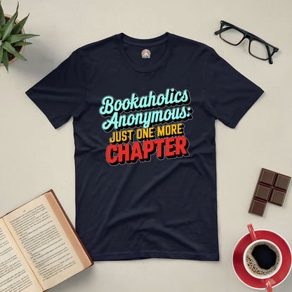 Bookaholics Anonymous Tee with "Just One More Chapter" text surrounded by books, glasses, chocolate, and coffee.