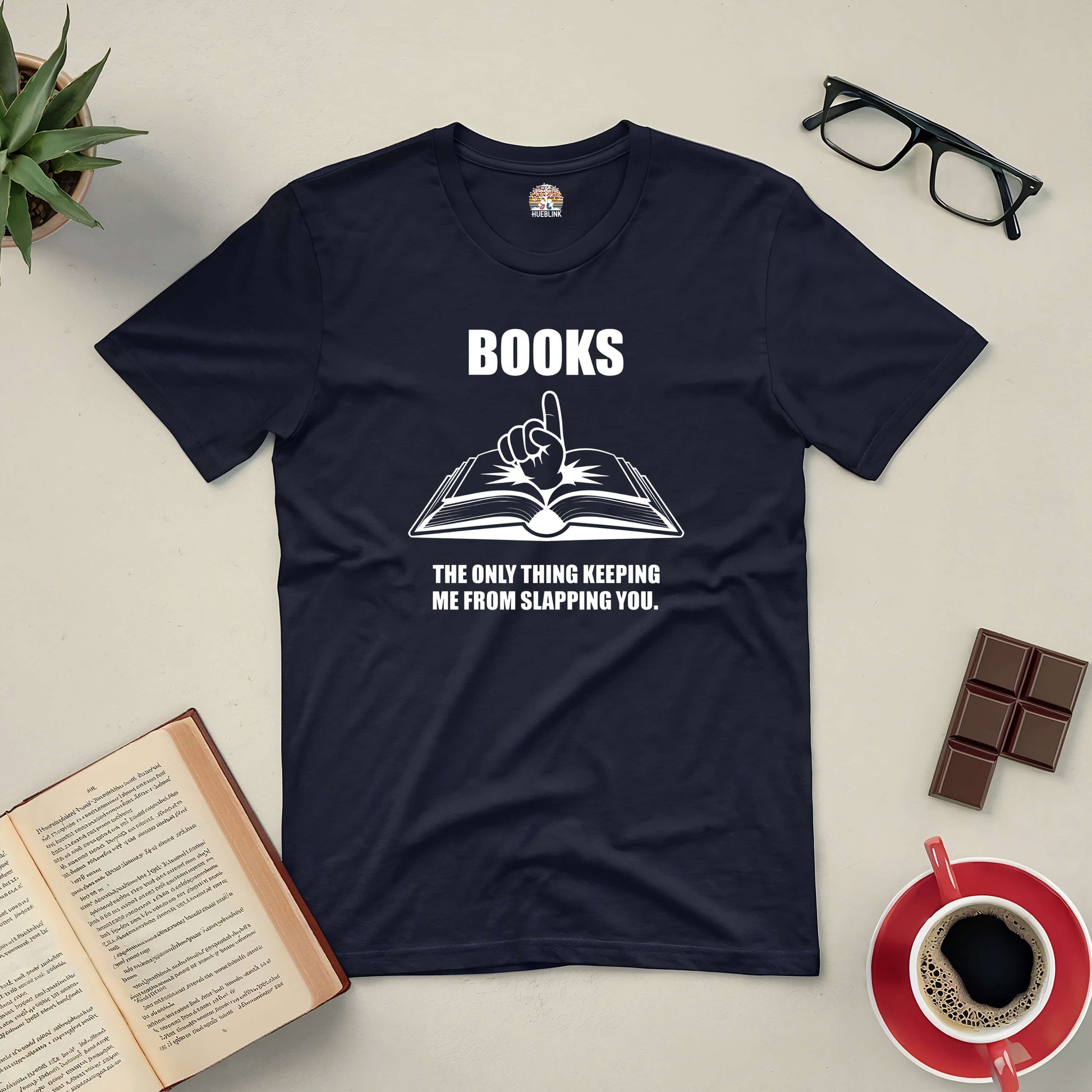 Black tee with text "Books: The Only Thing Keeping Me from Slapping You" surrounded by open book, glasses, and coffee.