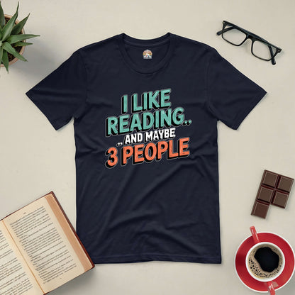 "I Like Reading... and Maybe 3 People" tee for introverted book lovers, surrounded by book, glasses, coffee, and chocolate.