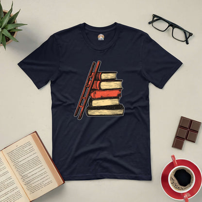 "Reaching New Heights Tee featuring a ladder and stacked books, symbolizing the journey of knowledge and exploration through reading."