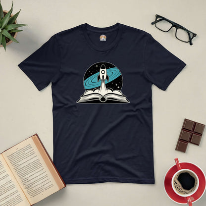 "It's Not Rocket Science tee featuring a rocket and book design, surrounded by glasses, a book, coffee, and chocolate."