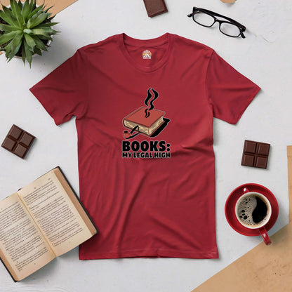 Red "Books: My Legal High" tee surrounded by books, coffee, chocolates, and glasses on a tabletop.