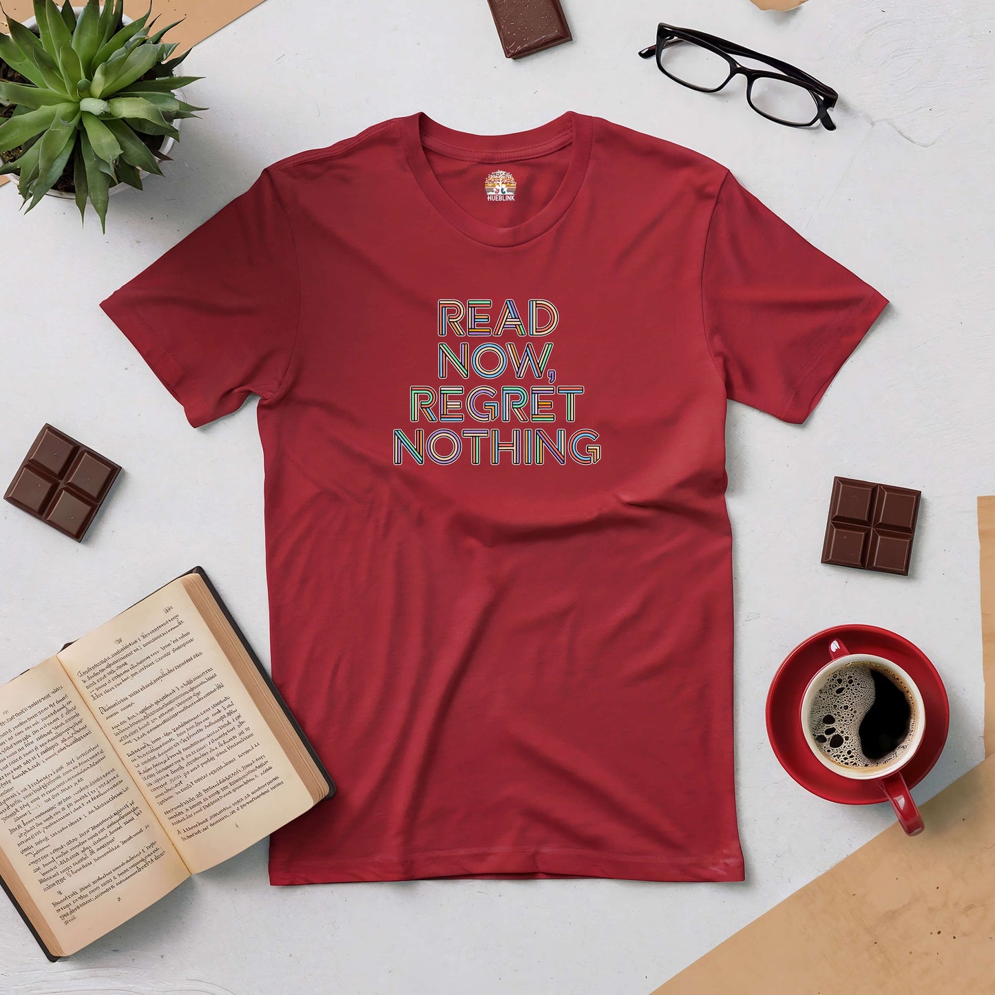 "Read Now, Regret Nothing Tee in red with book and coffee, perfect for book lovers embracing every story without hesitation"