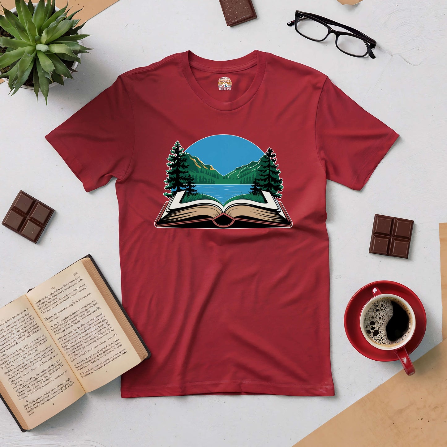 Red "Book Your Escape" tee with an open book and mountain design, perfect for nature lovers and book enthusiasts.