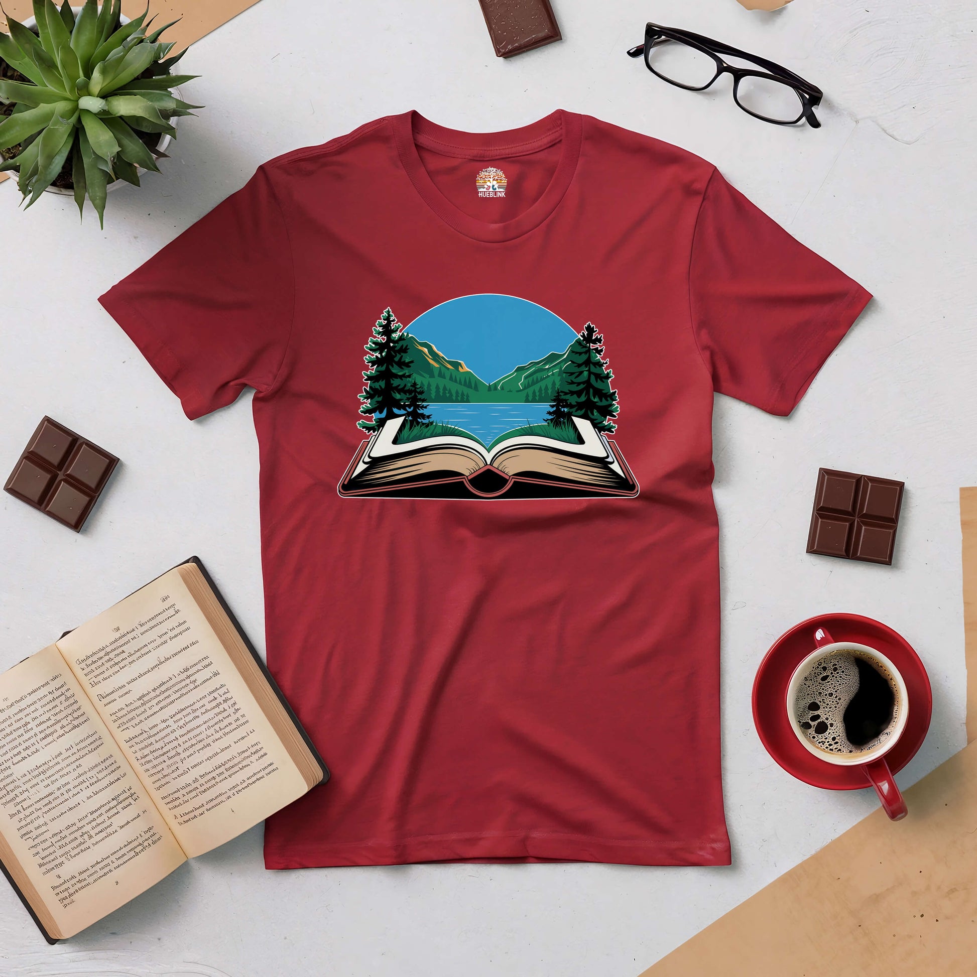 Red "Book Your Escape" tee with an open book and mountain design, perfect for nature lovers and book enthusiasts.