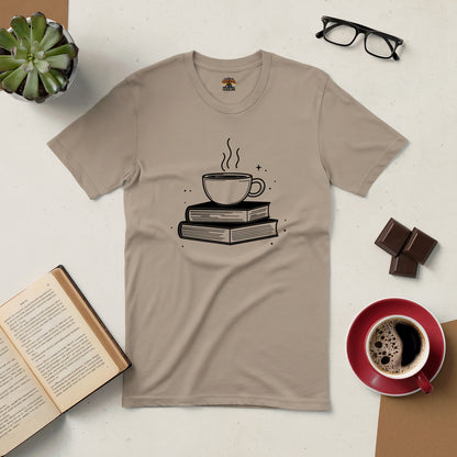 "Brewed for Books Tee featuring coffee cup and book design, surrounded by open book, coffee cup, and glasses on a cozy surface"