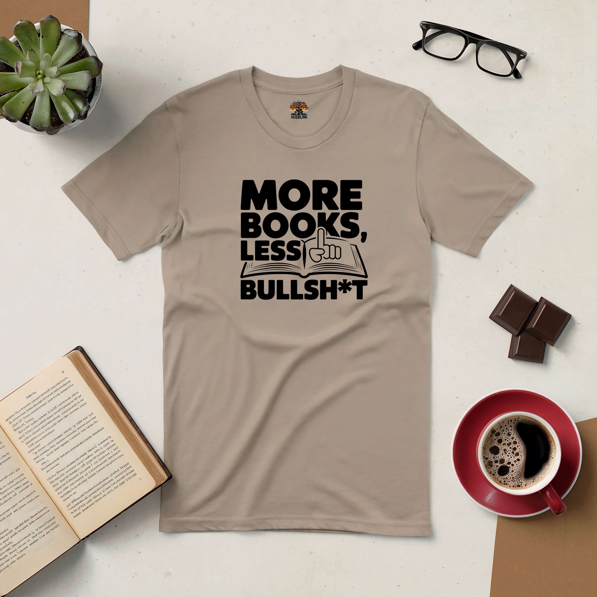 "More Books, Less Bullsh*t tee for book lovers with coffee, chocolate, and open book on table"