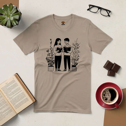 Bookish Buddies Tee with illustration of two friends reading, surrounded by books and plants, perfect for book lovers.