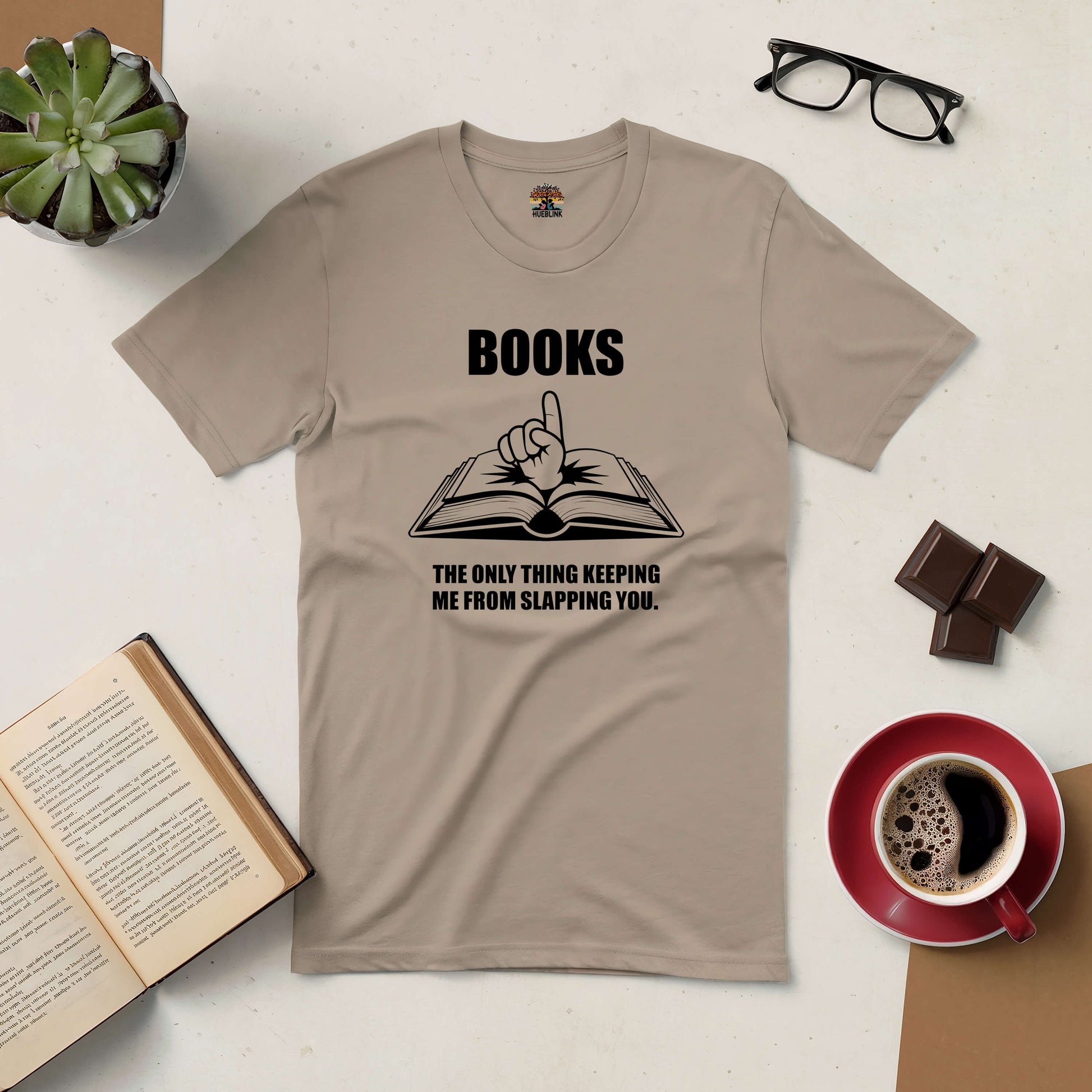 Beige t-shirt with the text "Books: The Only Thing Keeping Me from Slapping You," humorously conveying a book lover's attitude.