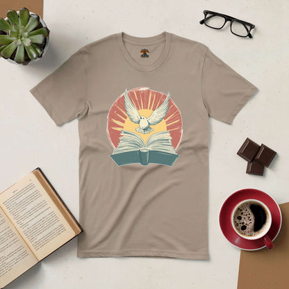 Boundless Horizons Tee with book and soaring bird design, surrounded by coffee, glasses, chocolate, and an open book on a table.